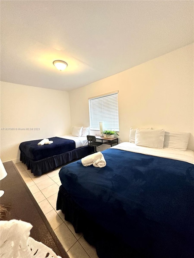 bedroom with light tile flooring