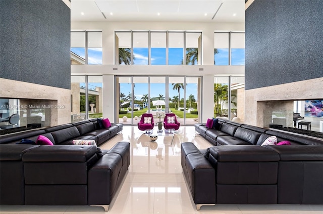 tiled living room featuring plenty of natural light and a towering ceiling