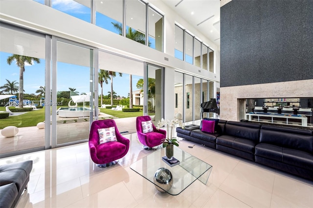 tiled living room featuring plenty of natural light, a high ceiling, and french doors