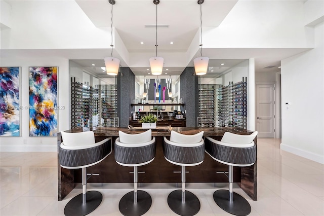 bar with light tile flooring and pendant lighting