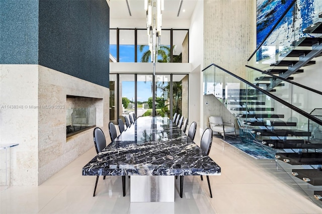 dining space featuring light tile floors and a towering ceiling