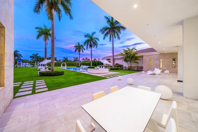 patio terrace at dusk with a lawn