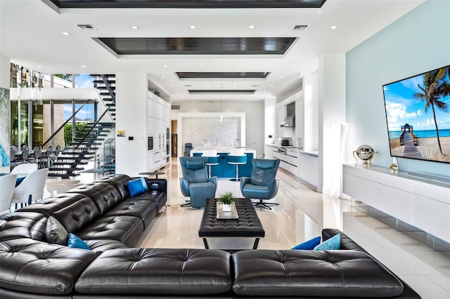 tiled living room featuring a tray ceiling