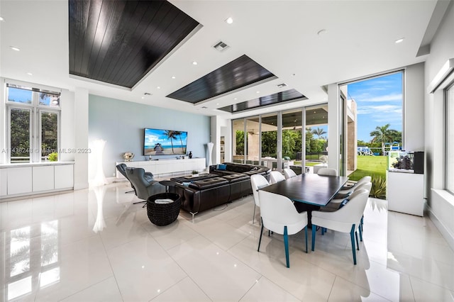 tiled dining space with a healthy amount of sunlight and expansive windows