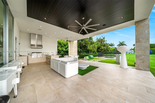 view of terrace with a grill, an outdoor hangout area, an outdoor kitchen, and ceiling fan