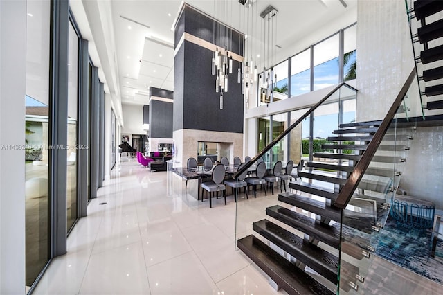 tiled entrance foyer featuring a towering ceiling