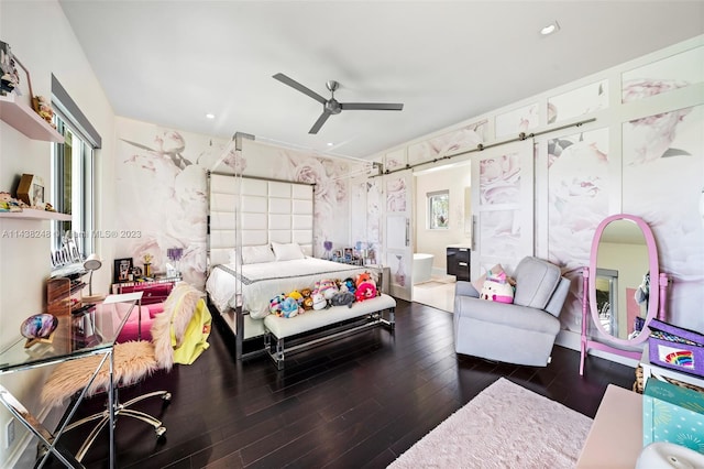 bedroom featuring ceiling fan, ensuite bath, and dark wood-type flooring