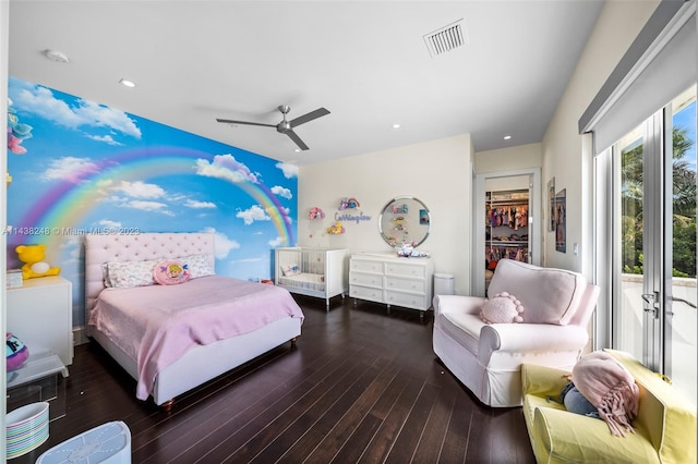 bedroom with ceiling fan, a walk in closet, dark hardwood / wood-style flooring, access to outside, and a closet