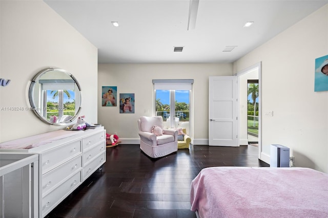 bedroom featuring dark wood-type flooring and multiple windows