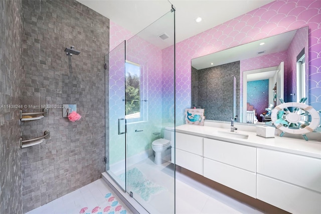 bathroom featuring tile walls, toilet, an enclosed shower, tile flooring, and vanity