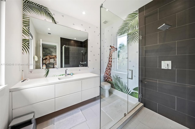 bathroom with oversized vanity, toilet, tile floors, and a shower with shower door