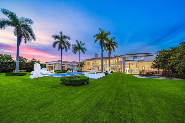 yard at dusk featuring a patio