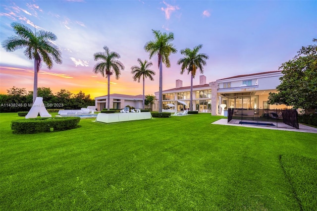 yard at dusk featuring a patio area and outdoor lounge area