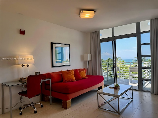 living room with a wall of windows and light tile floors