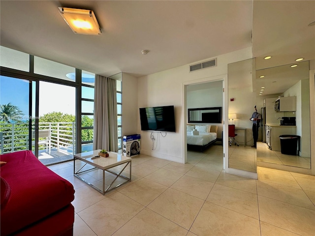 living room with light tile flooring and expansive windows