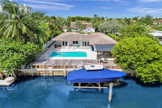 view of swimming pool with a dock and a patio