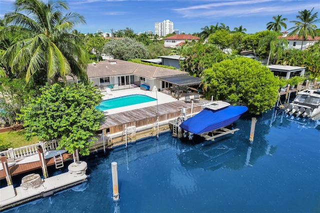 view of swimming pool featuring a boat dock and a patio