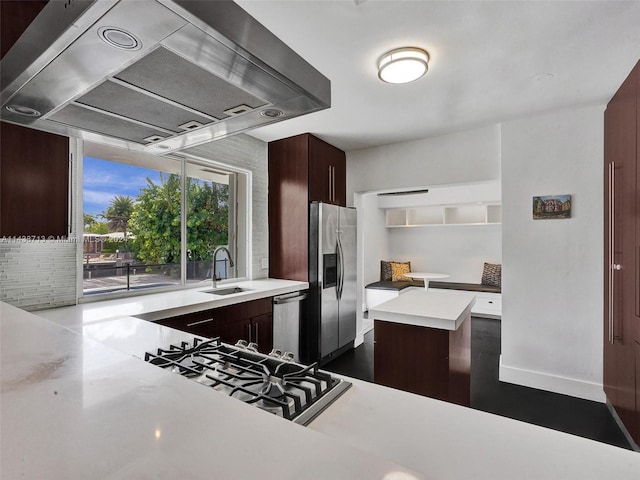 kitchen featuring a center island, stainless steel appliances, sink, and custom exhaust hood