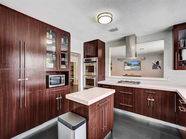 kitchen with dark tile patterned flooring, appliances with stainless steel finishes, and island exhaust hood