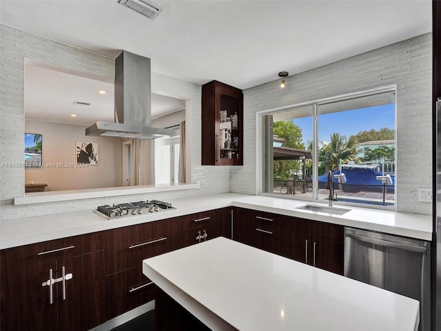 kitchen featuring stainless steel appliances, island exhaust hood, and sink