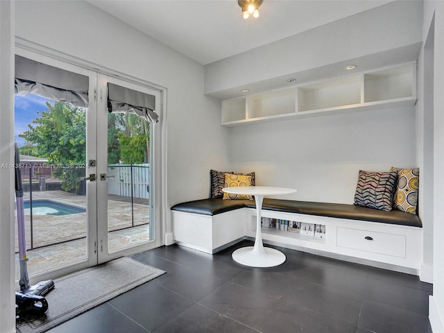 interior space with dark tile patterned flooring and french doors