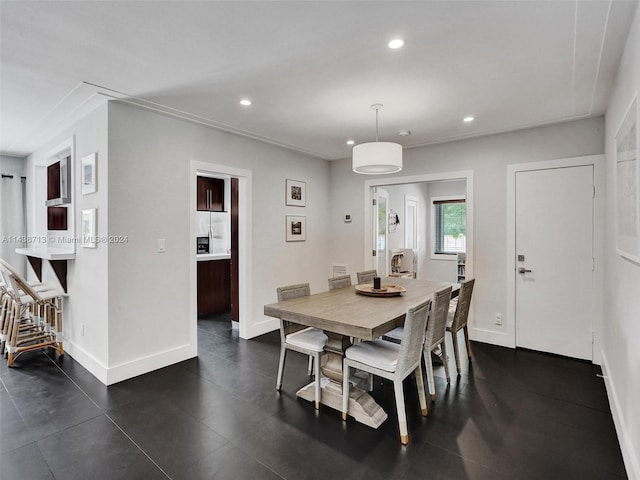 dining space with dark tile patterned floors