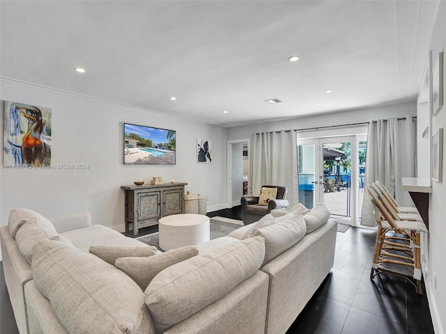 tiled living room featuring crown molding and french doors