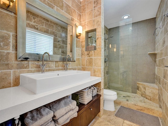 bathroom with tiled shower, tile walls, and toilet