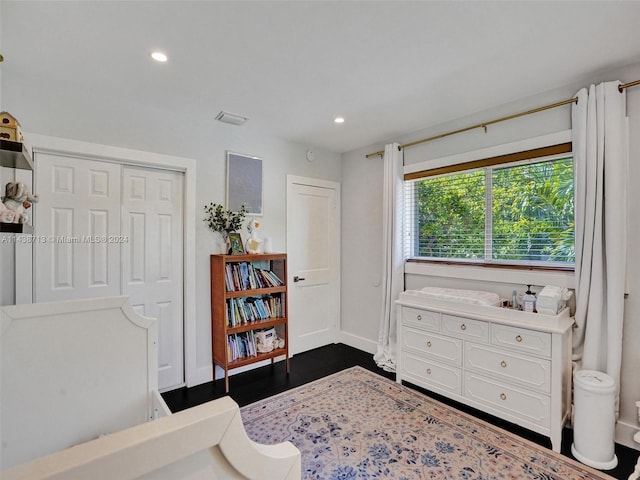 bedroom featuring a closet and dark hardwood / wood-style flooring