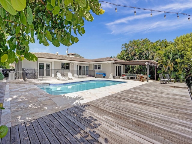 view of swimming pool with a deck