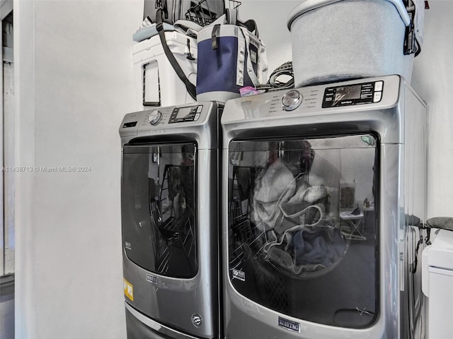 clothes washing area featuring washer and clothes dryer