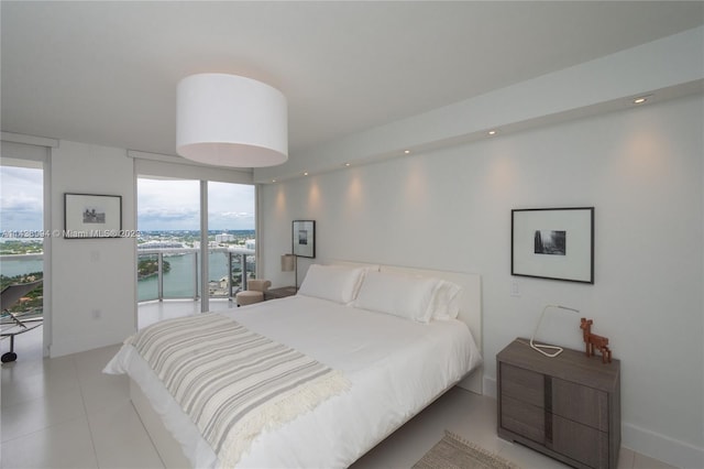 tiled bedroom featuring access to outside, floor to ceiling windows, and a water view