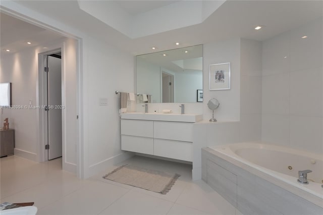 bathroom with a relaxing tiled bath, tile flooring, large vanity, and a raised ceiling