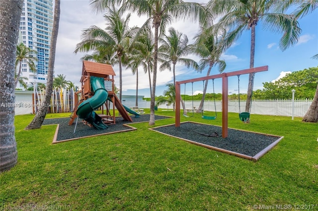 view of jungle gym featuring a water view and a yard