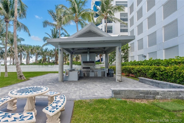 view of home's community with a lawn, a patio, a gazebo, and exterior kitchen