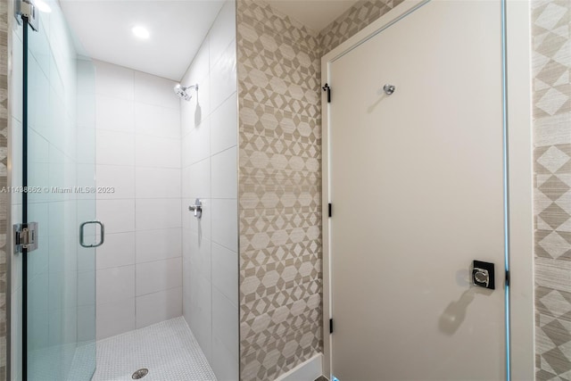 bathroom with a shower with door