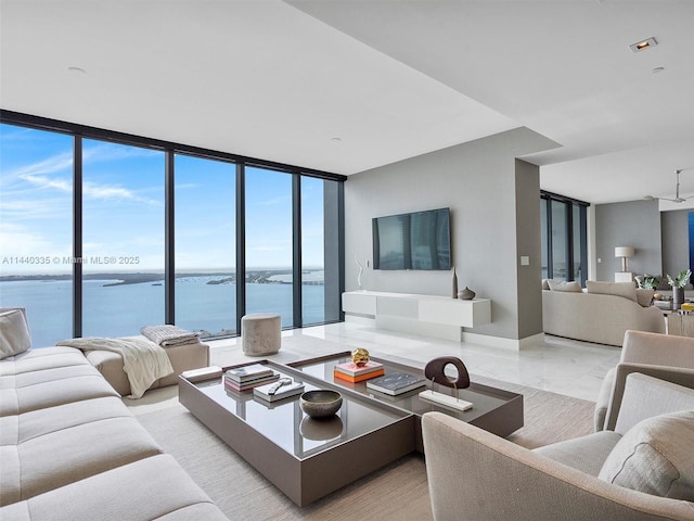 living room with marble finish floor and a wall of windows