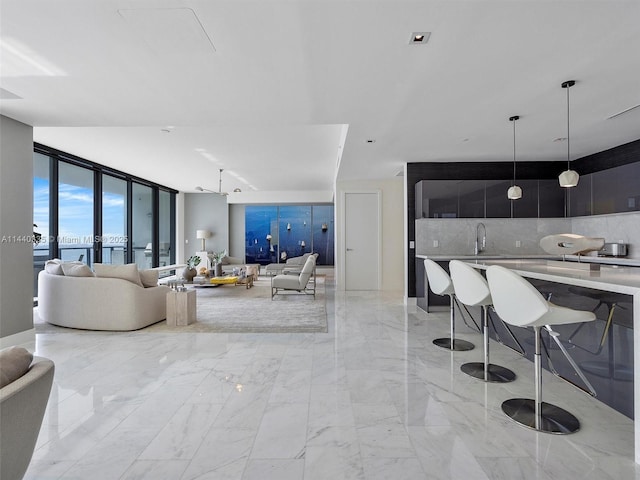 living area with marble finish floor and a wall of windows