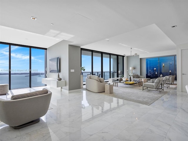 living room featuring expansive windows, marble finish floor, and visible vents