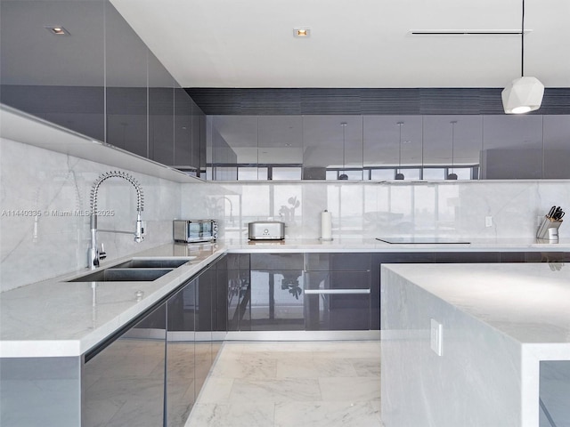 kitchen with hanging light fixtures, modern cabinets, and a sink