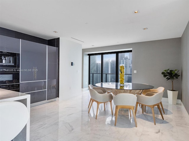 dining room with recessed lighting and marble finish floor