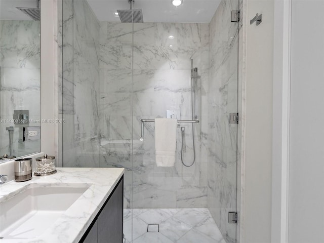 bathroom with recessed lighting, vanity, and a marble finish shower