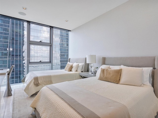 bedroom featuring floor to ceiling windows and tile patterned floors