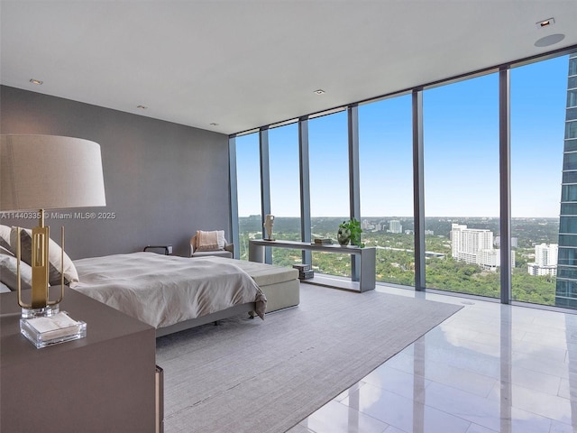 bedroom featuring a view of city, multiple windows, floor to ceiling windows, and light tile patterned flooring