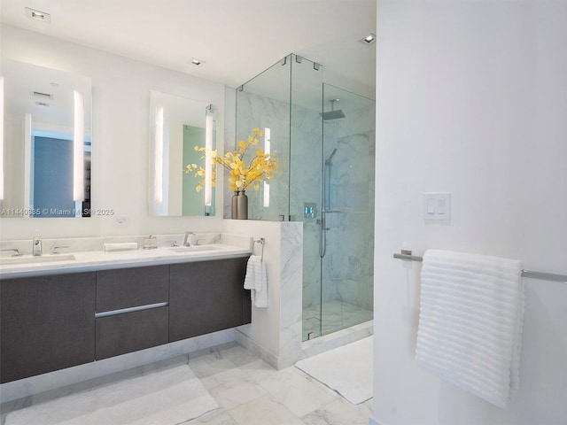 bathroom with marble finish floor, a marble finish shower, and a sink