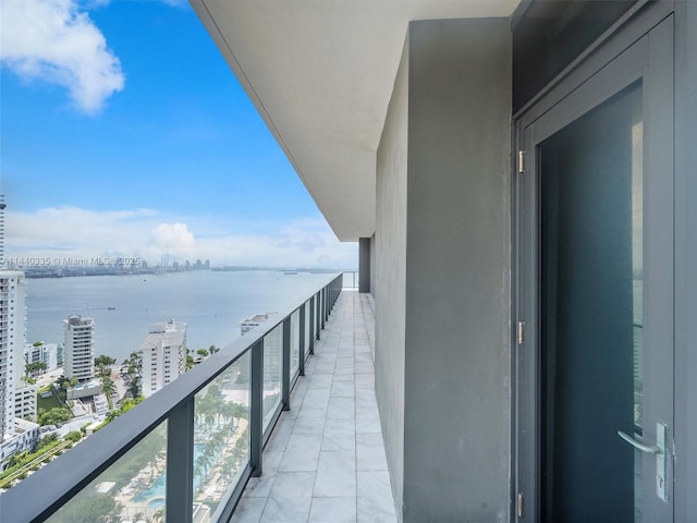 balcony with a water view and a city view