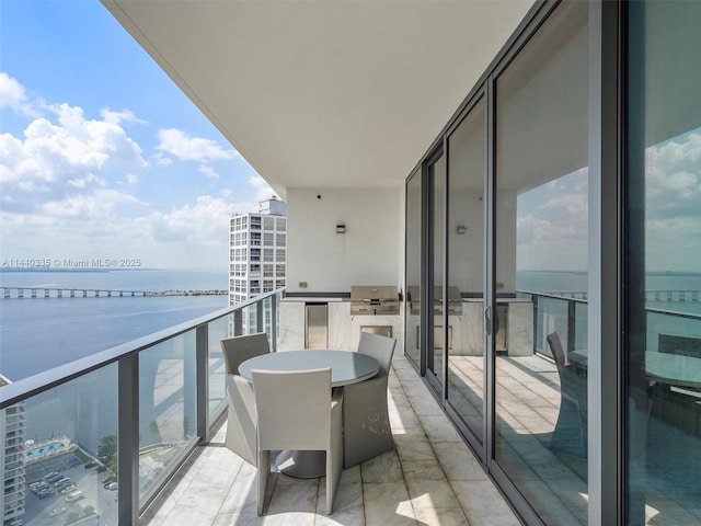 balcony featuring a water view and area for grilling