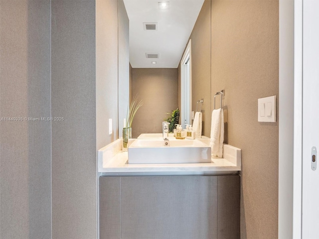 bathroom with vanity and visible vents