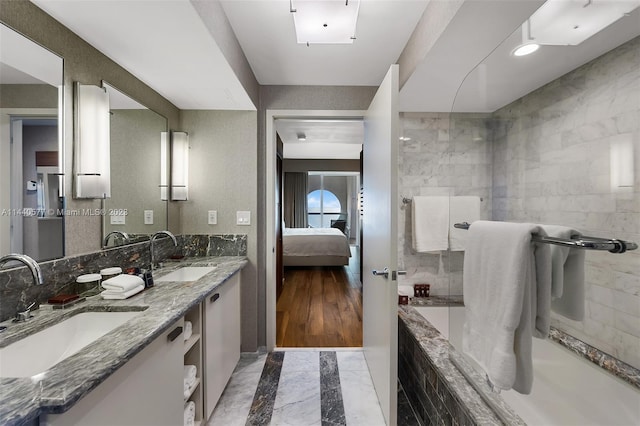 bathroom with tile walls, double sink vanity, and tile flooring