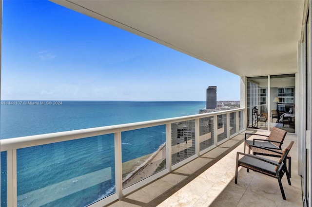 balcony featuring a water view